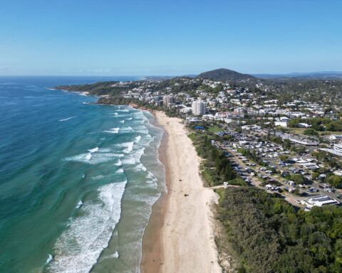 Aerial, drone view of the amazing Coolum Beach on the Sunshine Coast north of Brisbane Queensland Australia. Beautiful beachfront with breaking ocean waves.