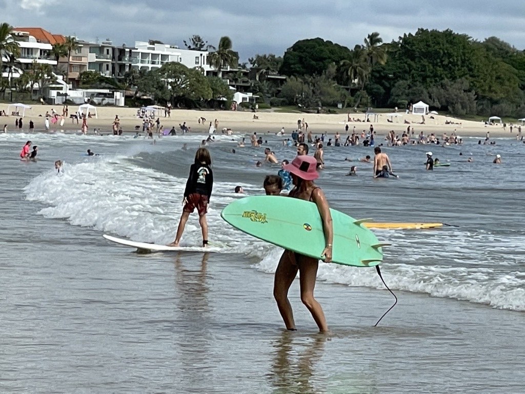 Surfer with green board at Noosa Main Beach