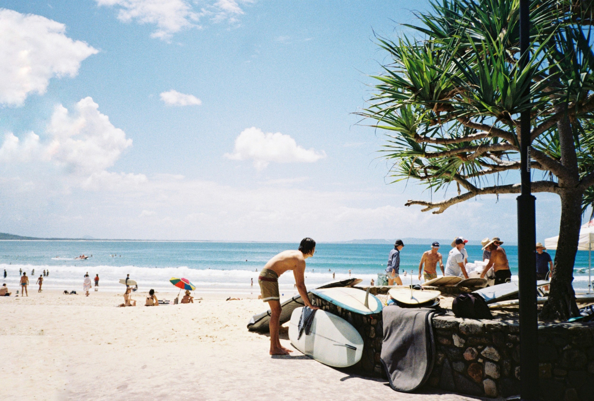 Noosa Main Beach - man with surf boards 