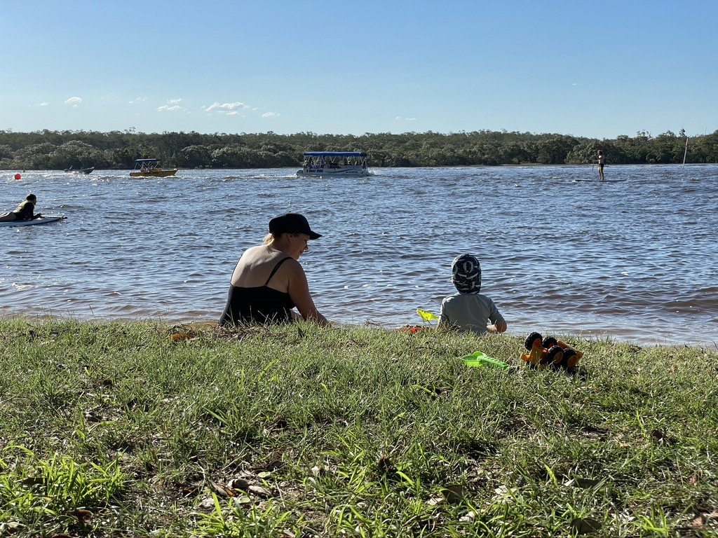 Mother and child on playing on the banks of Noosa River